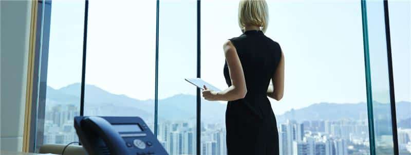 Business woman standing with tablet