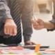 Business people pointing to table