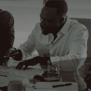Three co-workers working on paperwork in meeting room