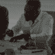 Three co-workers working on paperwork in meeting room