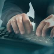 Hands typing on keyboard