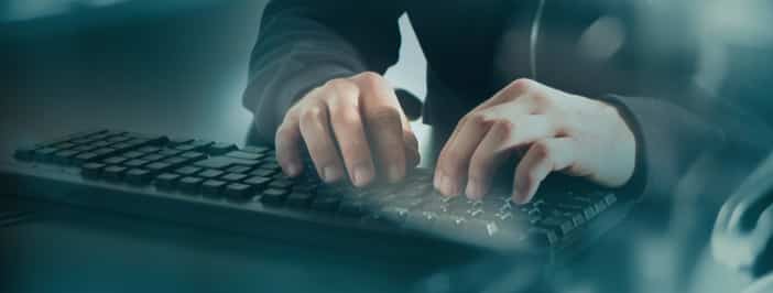 Hands typing on keyboard