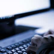Hands typing on keyboard