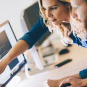 Two IT technicians working on desktop computer