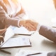 Business man shaking a business woman's hand