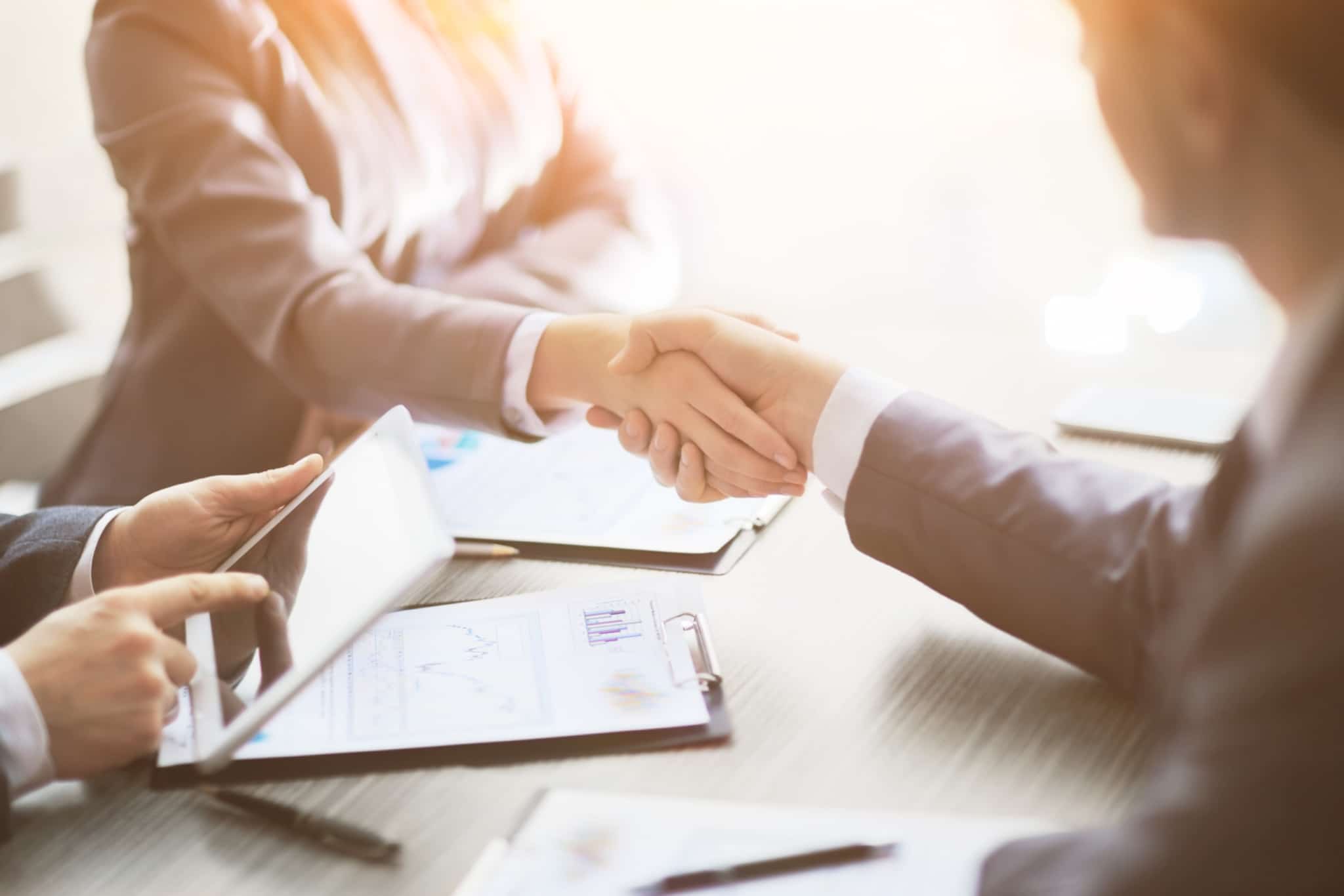 Business man shaking a business woman's hand