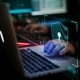 man typing on Laptop with holograph lock screen
