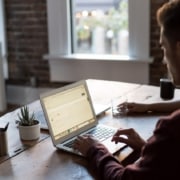 the role of firewalls in defending data - man types on laptop at table