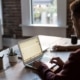 the role of firewalls in defending data - man types on laptop at table