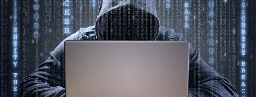 hacker in hoodie types on computer with code in background - security incident response panel