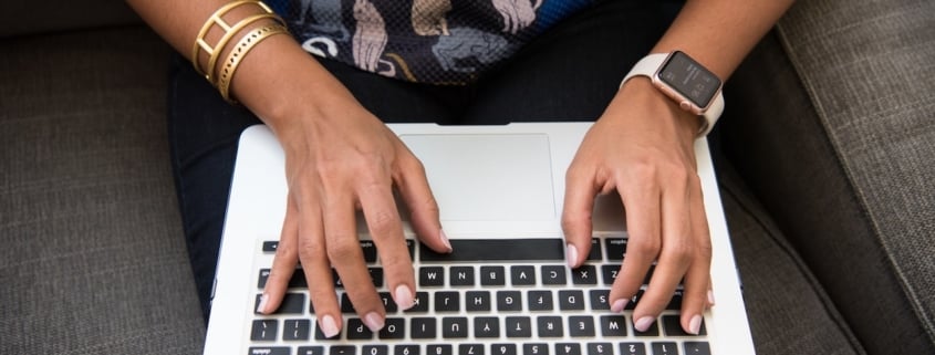 hands on a computer laptop representing endpoint protection