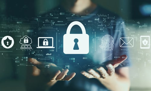 lock icon and other computer symbols above hands representing cybersecurity