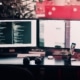 two computer screens set up as part of the business hardware at an Oklahoma IT company