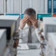 stressed Man holding his face in his hands