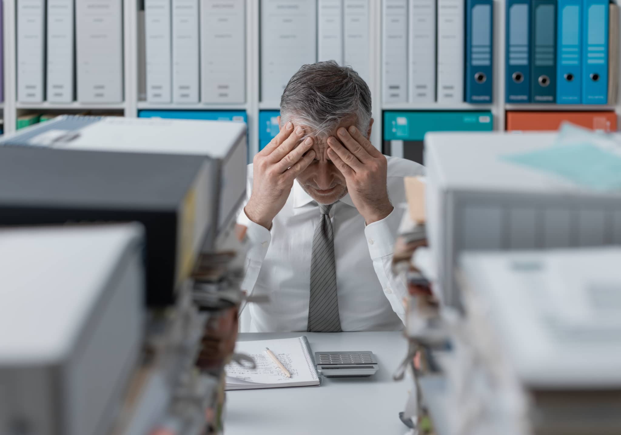 stressed Man holding his face in his hands