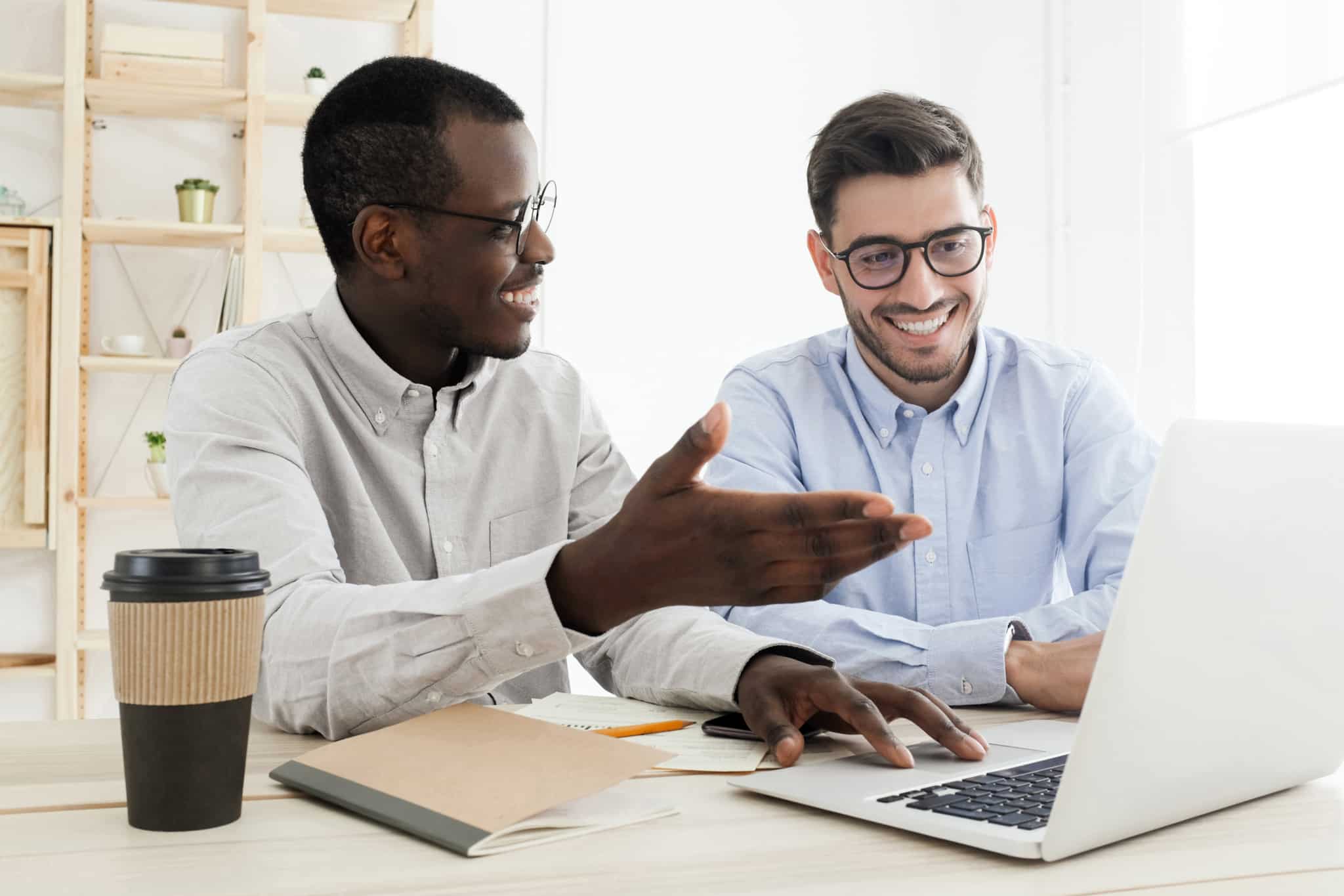 businessman discussing work in front of laptop