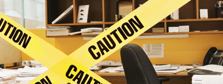 Caution tape in front of office cubicle