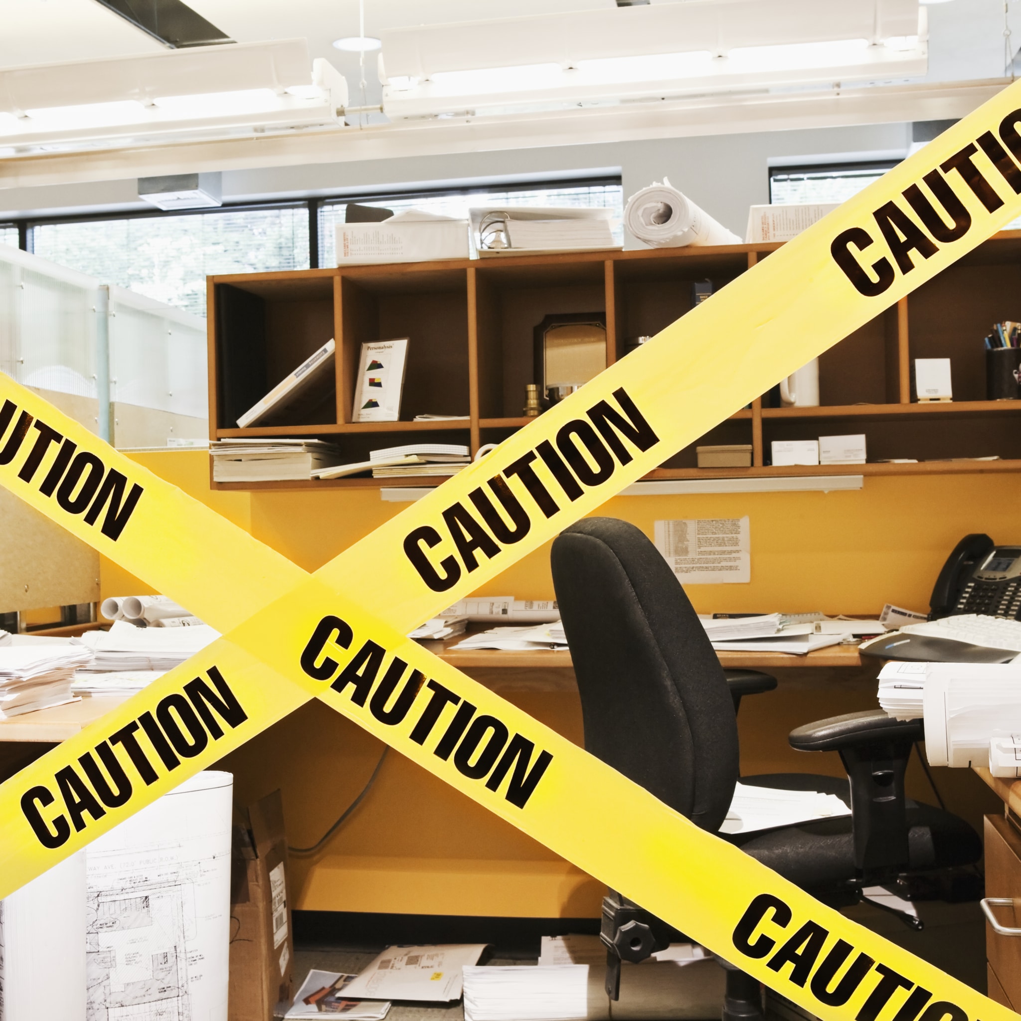 Caution tape in front of office cubicle